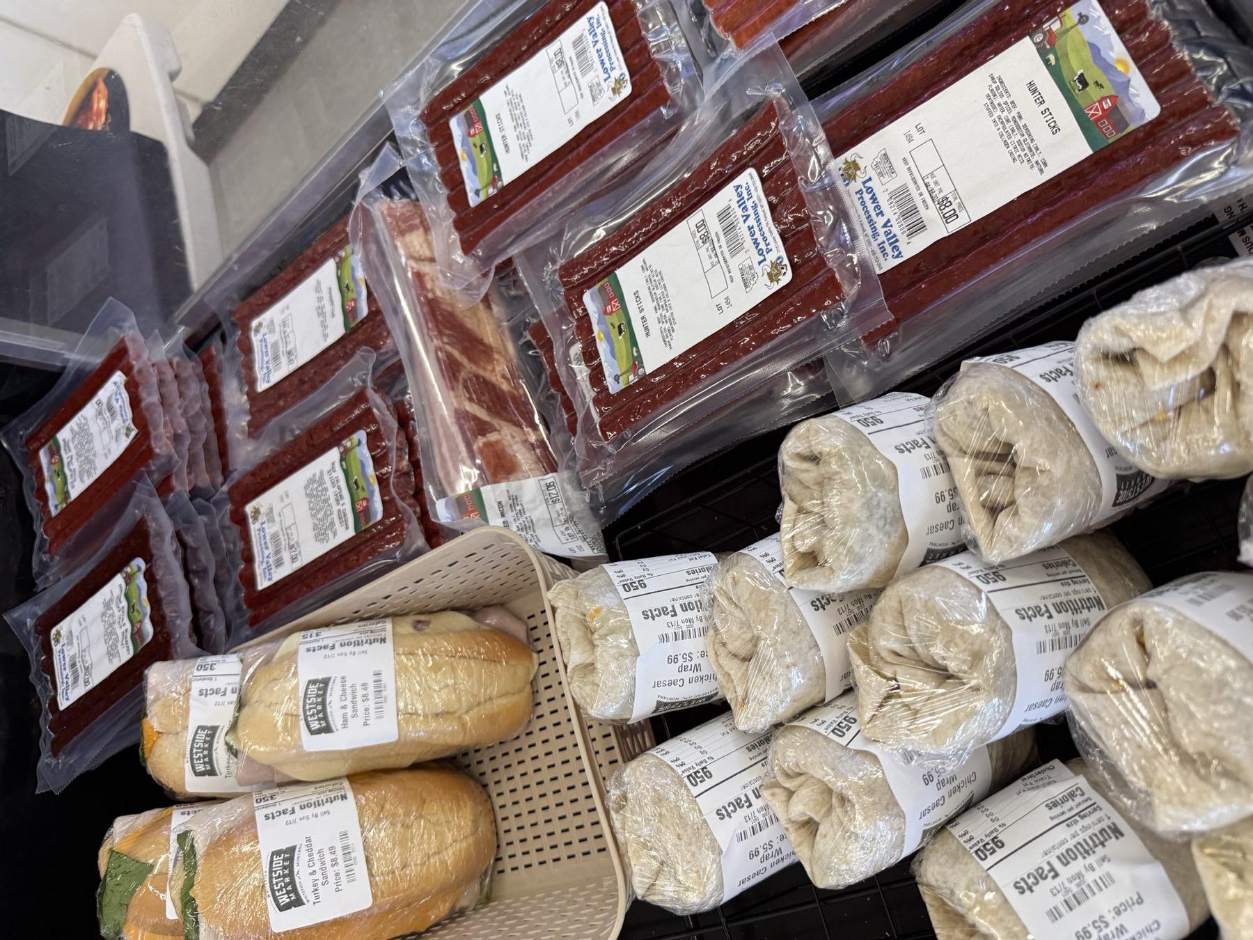 Packaged goods and fresh bread on the counter at West Side Market, Whitefish.